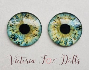 May include: Two blue, green, and yellow glass doll eyes with black pupils.