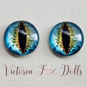 May include: Two blue glass eyes with a black pupil and yellow iris. The eyes are round and have a glossy finish.