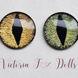 May include: Two round, black-rimmed, glass eyes with a black, diamond-shaped pupil. One eye is gold with glitter, the other is green with glitter.