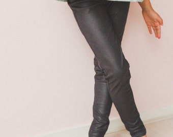 May include: A pair of black, shiny leggings. The leggings are fitted and have a slight sheen.
