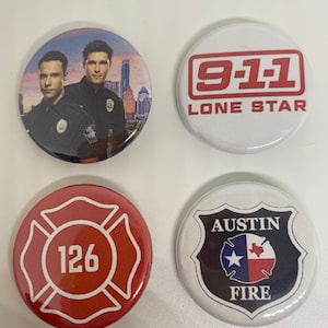 May include: Four round buttons with different designs. The first button features a photo of two men in police uniforms. The second button has a white background with red text that reads "9-1-1 LONE STAR". The third button has a red background with a white cross and the number "126". The fourth button has a white background with a black shield that reads "AUSTIN FIRE" with a white star and a red and white Texas flag.