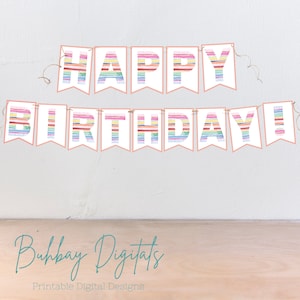 May include: A printable Happy Birthday banner with rainbow striped letters. The letters are white with a pink outline and are strung together with twine.