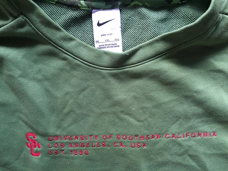 May include: Green sweatshirt with the text "UNIVERSITY OF SOUTHERN CALIFORNIA LOS ANGELES, CA, USA EST. 1880" in red.