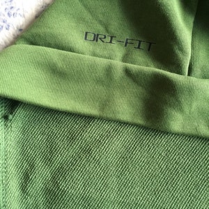May include: Green hooded sweatshirt with the text "DRI-FIT" on the inside of the hood.