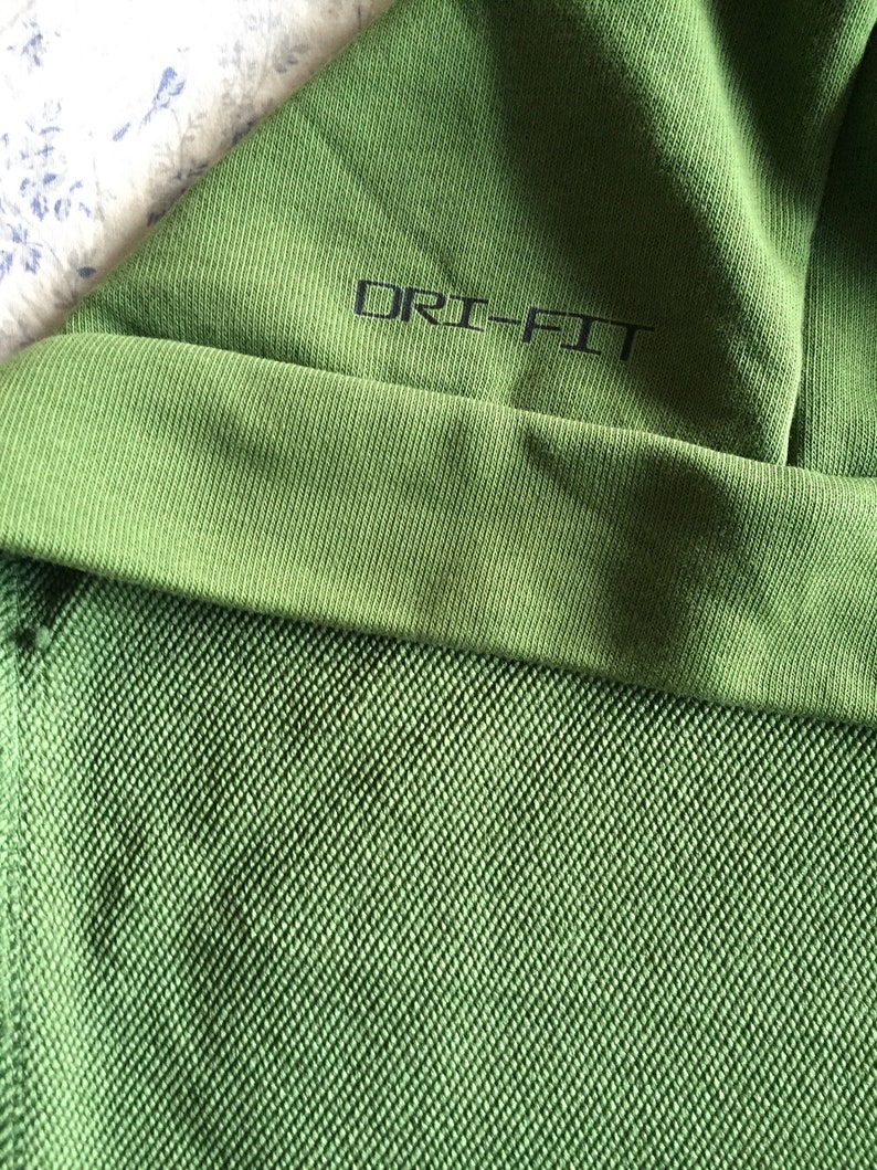 May include: Green hooded sweatshirt with the text "DRI-FIT" on the inside of the hood.