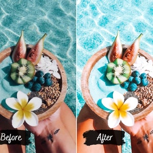 May include: A wooden bowl filled with a blue smoothie topped with kiwi, figs, blueberries, and granola. A white flower sits on top of the smoothie.