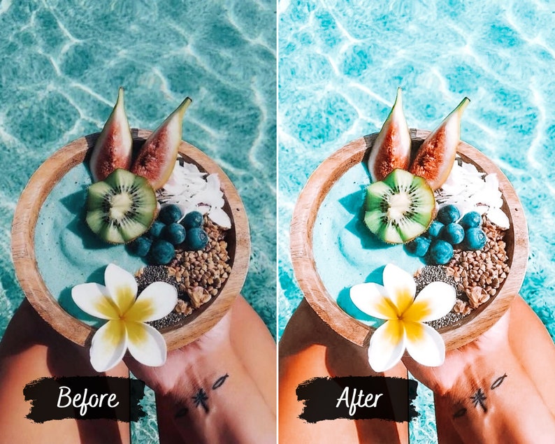 May include: A wooden bowl filled with a blue smoothie topped with kiwi, figs, blueberries, and granola. A white flower sits on top of the smoothie.
