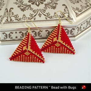 May include: A pair of handmade, triangular earrings. The earrings are red with gold accents, featuring a beaded design. The earrings have gold-colored ear wires. The text "BEADING PATTERN ~ Bead with Bugs" is at the bottom of the image.