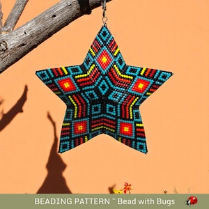 May include: A beaded star ornament with a geometric pattern in shades of blue, red, yellow, and black. The star is hanging from a branch against a peach-colored wall.