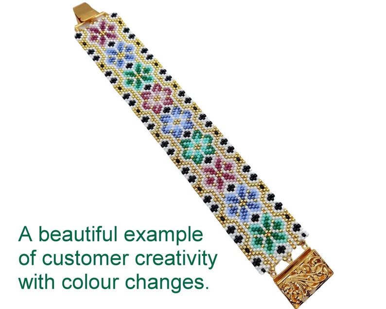 May include: A white beaded bracelet with a gold clasp. The bracelet features a repeating pattern of colorful flowers and black beads.