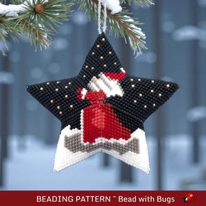 May include: A beaded star Christmas ornament with a black background and gold accents. The ornament features a red dress design and the text "BEADING PATTERN ~ Bead with Bugs". The star is hanging from a snowy pine branch.