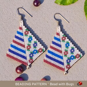 May include: A pair of beaded earrings with a geometric design. The earrings are made with white, blue, red, and green beads. The earrings are in the shape of a triangle and have a silver hook.