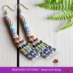 May include: A pair of long, colorful beaded earrings with a rainbow pattern. The earrings are made with small, white beads and have a gold hook.