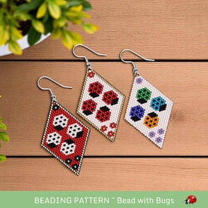 May include: Three pairs of beaded earrings with a diamond shape. Each earring features a different design of ladybugs with black, red, white, orange, green, and blue beads.