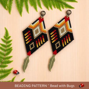 May include: A pair of beaded earrings with a geometric pattern in black, red, yellow, and white. The earrings have a feather charm and a silver hook.