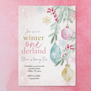 May include: A winter wonderland themed first birthday party invitation with a watercolor illustration of a snowy evergreen branch with ornaments and candy canes. The text reads "Join us in a winter one derland Olivia is turning one December 15 at 10:00 am 123 Pine Street Dallas, TX 75202 RSVP to Hollie 123.456.7890"