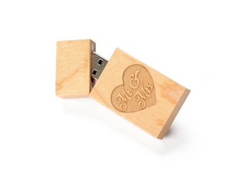 May include: A wooden USB flash drive with a heart-shaped design and the text "Mr & Mrs" engraved on it.