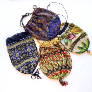 May include: Four vintage beaded purses with intricate floral and geometric patterns in shades of blue, green, gold, and red. The purses have drawstrings and tassels.