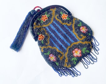 May include: A vintage beaded evening bag with a blue and gold floral design. The bag has a black beaded fringe and a black plastic clasp.