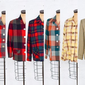 May include: A selection of vintage plaid blazers in various colours, including red, green, and yellow. Each blazer features a collared neckline, button closures, and front pockets. The jackets are displayed on dress forms against a white background.