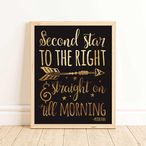 May include: A framed print with a black background and gold lettering. The text reads "Second star to the right, straight on 'til morning" with an arrow illustration. The quote is from Peter Pan.