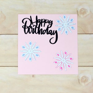 Carte d'anniversaire hiver flocon de neige - papier cartonné rose pâle - flocons de neige bleus et roses - centres irisés - anniversaire d'hiver - 5 1/2" x 5 1/2"