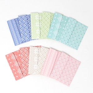 May include: A collection of colorful, patterned envelopes in shades of blue, green, pink, and beige. Each envelope features a unique geometric or snowflake design. The envelopes are arranged in a fan shape against a white background.