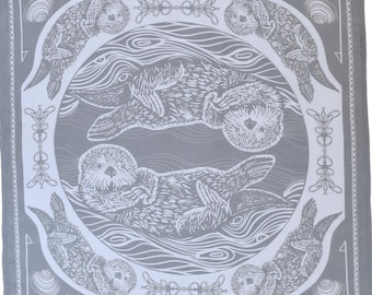 May include: A square, gray bandana with a white otter illustration. The design features otters in a circular pattern, surrounded by decorative elements and the text "HEARTH & HARROW" at the bottom. The bandana is made of a soft fabric.