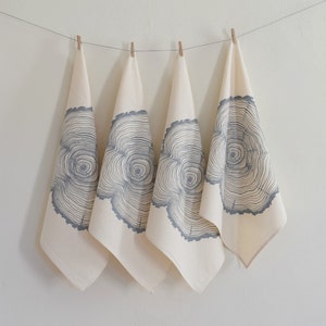 May include: Set of four kitchen towels with a gray tree ring design on a white background.