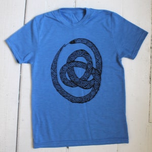 May include: A blue t-shirt with a black and white snake design. The snake is in a knot shape and has a geometric pattern.