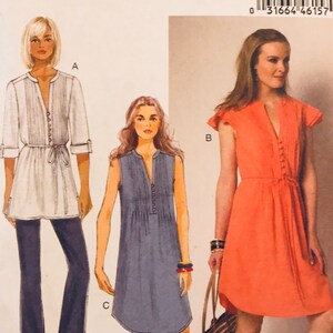 May include: Butterick sewing pattern B6208 for sizes 14-16-18-20-22. The envelope features illustrations of three garment variations: a white tunic with long sleeves, a blue sleeveless dress, and an orange dress with flutter sleeves.