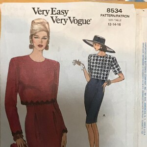 May include: A sewing pattern for a dress with a ruffled hem and long sleeves. The pattern is for sizes 12-14-16. The pattern is called "Very Easy Very Vogue" and the pattern number is 8534.