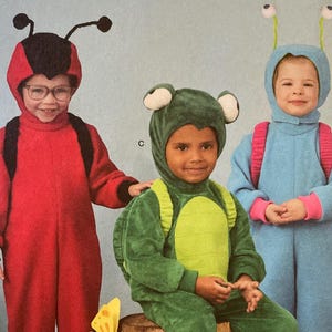 May include: Simplicity Costumes pattern featuring children's costumes. The costumes include a ladybug, frog, and a bug. The pattern includes sizes 1/2-4. The costumes are easy-to-sew.