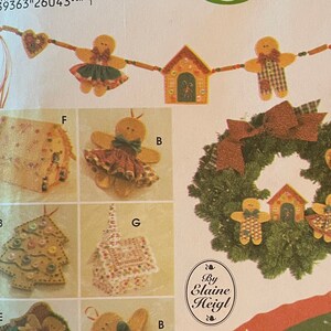 May include: A Simplicity Crafts pattern for making felt Christmas ornaments. The pattern includes instructions for making a gingerbread house, a wreath, a Christmas tree, a gingerbread man, and a garland. The pattern is by Elaine Heigl.