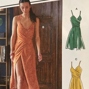 May include: A McCall's sewing pattern showing a woman in an orange dress with a high slit. The pattern includes illustrations of a green and a yellow dress. The text reads "#MeadowMcCalls" and "Designed and printed in USA."