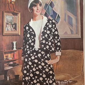 May include: A vintage Vogue Paris Original sewing pattern featuring a black and white floral print dress and jacket designed by Jacques Heim. The pattern number is 1588.