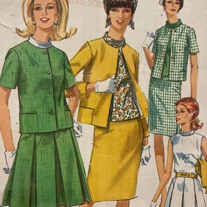 May include: Vintage Simplicity sewing pattern with illustrations of women in outfits. The pattern includes a green skirt suit, a yellow skirt suit, and a white dress. The package is labeled "Miss Size 10, Bust 79 cm".