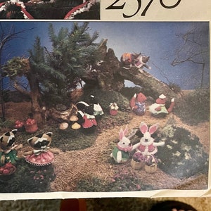 May include: A vintage Vogue Patterns sewing pattern featuring a Christmas tree and woodland animals. The pattern number is 2570 and the designer is Bettie Doolin.