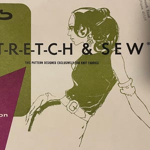 May include: Vintage sewing pattern titled "LADIES' SHELL" with the text "S-T-R-E-T-C-H & SEW". The cover features illustrations of a stick figure and a woman in a dress. Includes four collar variations and sizes 30-40.