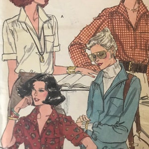 May include: Vintage sewing pattern for four different blouses. The pattern is for size 12 and is from Very Easy Vogue Patterns. The pattern shows four different women wearing the blouses in different colours and patterns.