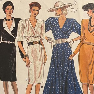 May include: Vogue's Basic Design pattern number 1811 for a wrap dress. The pattern shows four different styles of wrap dresses in various colors and patterns, including red and white floral, black, white, and blue polka dot.