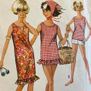 May include: Vintage Simplicity sewing pattern featuring three dress designs. The cover art shows illustrations of the dresses, including a floral print dress, a red gingham dress, and a striped top with shorts. The pattern is for a teen size 14T with a bust size of 34 inches.