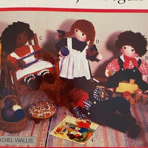 May include: A vintage sewing pattern for making three dolls. The pattern is called "Butterick 4252" and the dolls are named "The fun has just begun". The dolls are dressed in different outfits, including a red dress, a white dress, and a blue and white shirt and overalls.