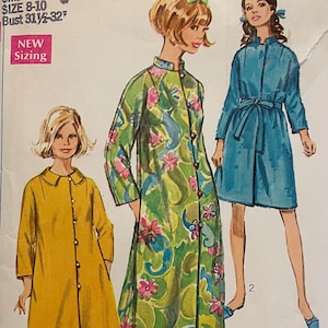 May include: Vintage Simplicity sewing pattern envelope featuring three illustrated women's fashion designs. The envelope includes the number 7958, size details, and the text "Jiffy". The designs include a yellow coat, a floral print coat, and a blue coat.