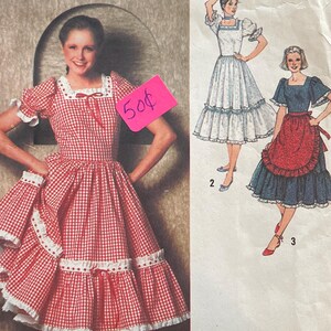 May include: Vintage Simplicity sewing pattern 9103. The pattern features illustrations of dresses, including a red and white gingham dress. The pattern is size 12 Miss. The price tag shows 50¢.