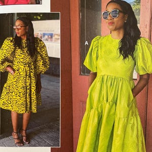 May include: A white ceramic mug with a black handle and the text "But First, Coffee" in a black, handwritten-style font. The mug is on a white surface.