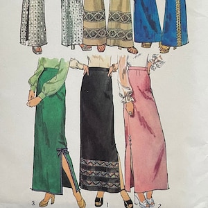 May include: A sewing pattern for a women's skirt and pants. The pattern includes four different styles: a green skirt with a side slit, a black skirt with a side slit and a decorative trim, a pink skirt with a side slit, and two styles of pants with side slits. The pattern is for size 14, with a 28 inch waist and 38 inch hip.