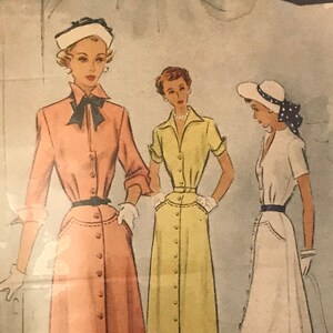 May include: Vintage McCall printed pattern for Ladies' & Misses' Dress, size 16, featuring three dress designs. The illustrations show dresses in peach, yellow, and white, each with button-down fronts and belted waists. The pattern includes the McCall logo and the number 7702.