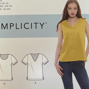 May include: A Simplicity sewing pattern, S9133, featuring three t-shirt designs. The pattern includes sizes U.S. 8-16, Euro. 34-42, and Fr. 36-44. The image shows a woman wearing a yellow V-neck top and blue jeans.