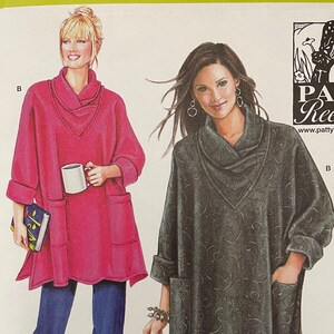 May include: Simplicity sewing pattern 2289 featuring two tunic designs. The pattern includes sizes XS-XXL. The cover shows a pink tunic with a cowl neck and a gray tunic with a floral pattern. The pattern is from Patty Reed Designs.